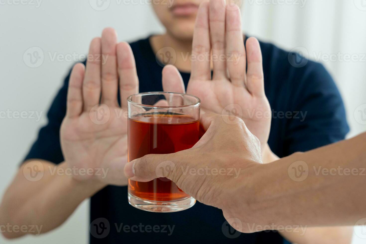 man refuses say no and avoid to drink an alcohol whiskey , stopping hand sign male, alcoholism treatment, alcohol addiction, quit booze, Stop Drinking Alcohol. Refuse Glass liquor, unhealthy, reject photo