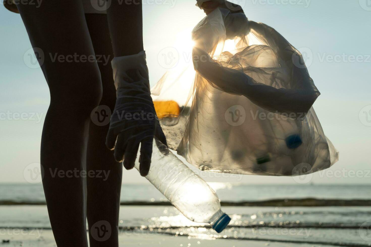 Save water. Volunteer pick up trash garbage at the beach and plastic bottles are difficult decompose prevent harm aquatic life. Earth, Environment, Greening planet, reduce global warming, Save world photo