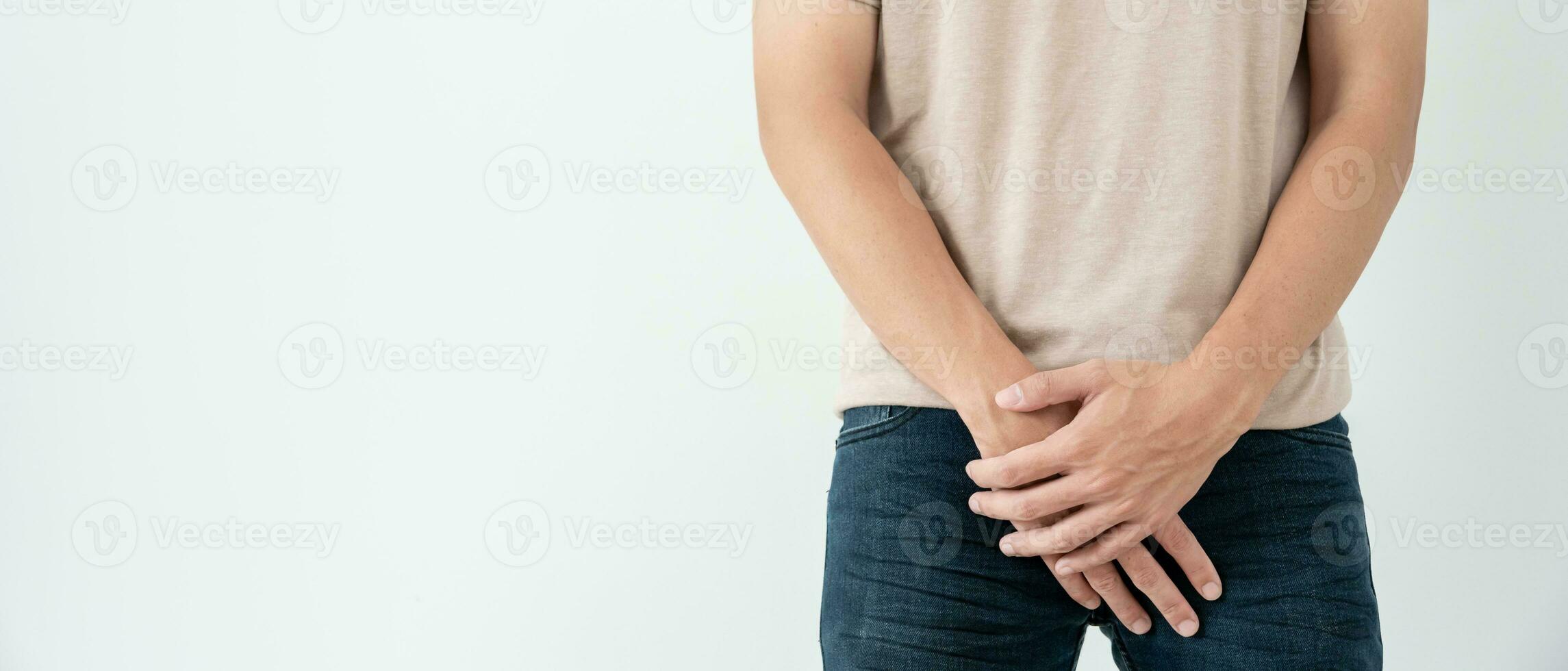 Man hold hand in front of private parts feeling discomfort from disease and inflammation. Venereal, testicular cancer. bladder problems, erectile dysfunction, premature ejaculation, prostate cancer photo