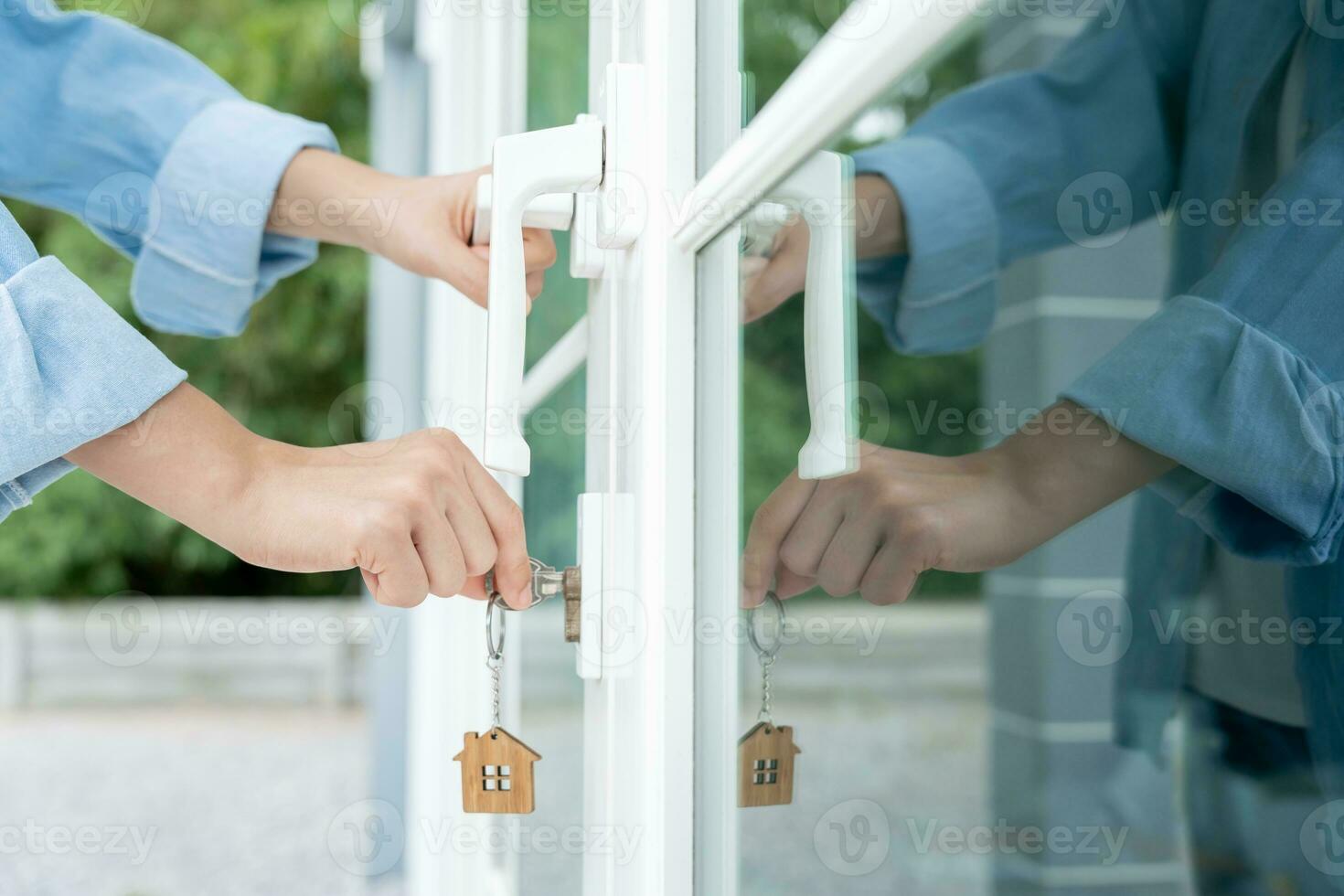 Landlord key for unlocking house is plugged into the door. Second hand house for rent and sale. Owner use hand unlock door mortgage for new home, buy, sell, renovate, investment, owner, estate photo