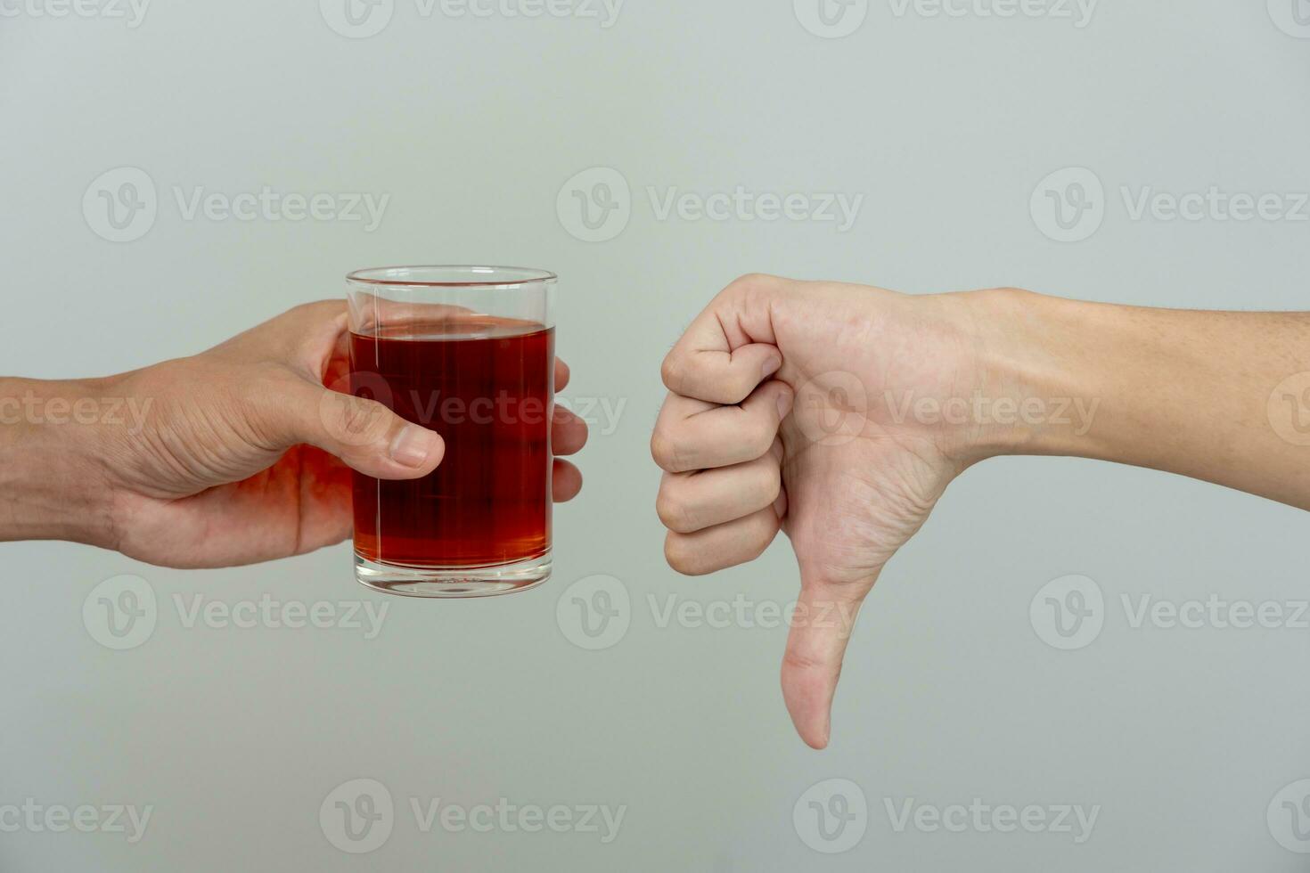 man refuses say no and avoid to drink an alcohol whiskey , stopping hand sign male, alcoholism treatment, alcohol addiction, quit booze, Stop Drinking Alcohol. Refuse Glass liquor, unhealthy, reject photo