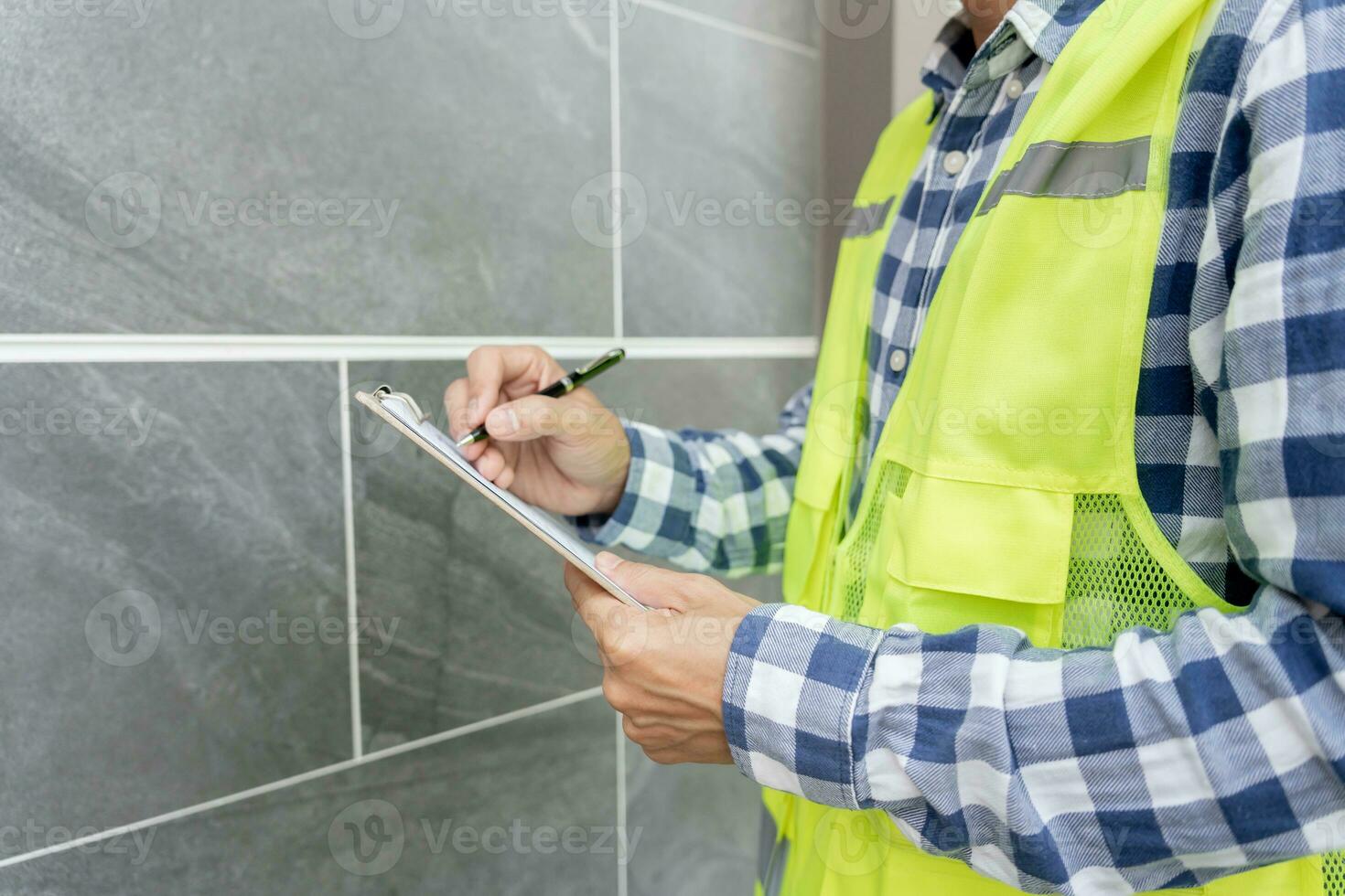 inspector or engineer is inspecting construction and quality assurance new house using a checklist. Engineers or architects or contactor work to build the house before handing it over to the homeowner photo