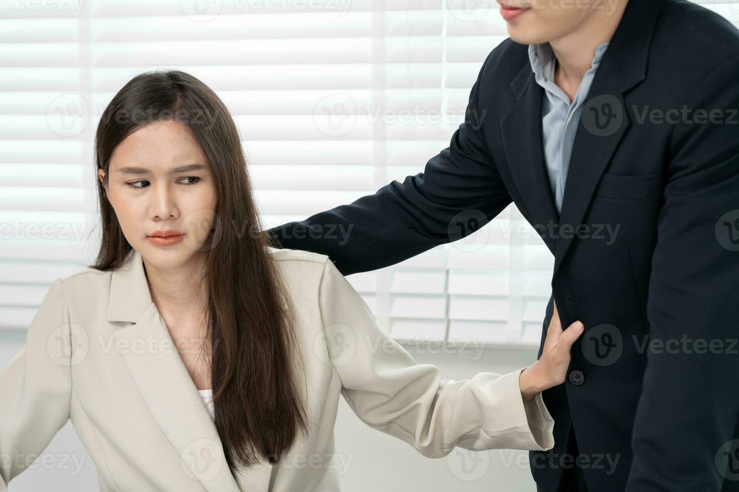 Manager or senior sexually harassed a female colleague by touch her shoulder. Sexual harassment in office. feel anxious and stressed from being harassed. molest, assault, inappropriate, discrimination photo