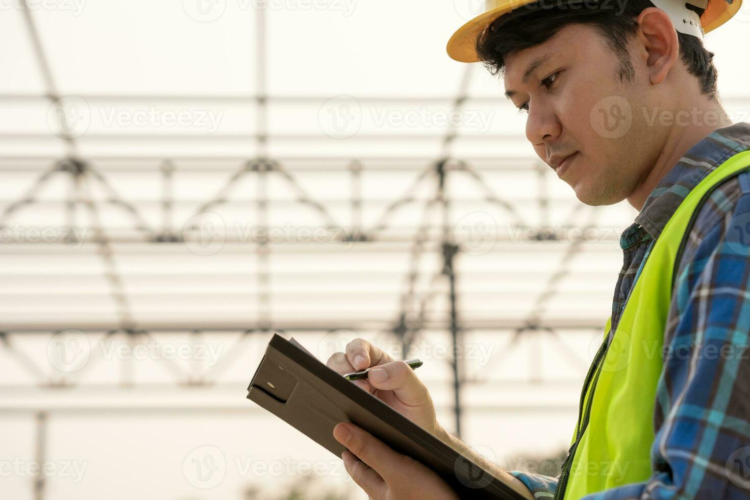 inspector or engineer is inspecting construction and quality assurance new house using a checklist. Engineers or architects or contactor work to build the house before handing it over to the homeowner photo
