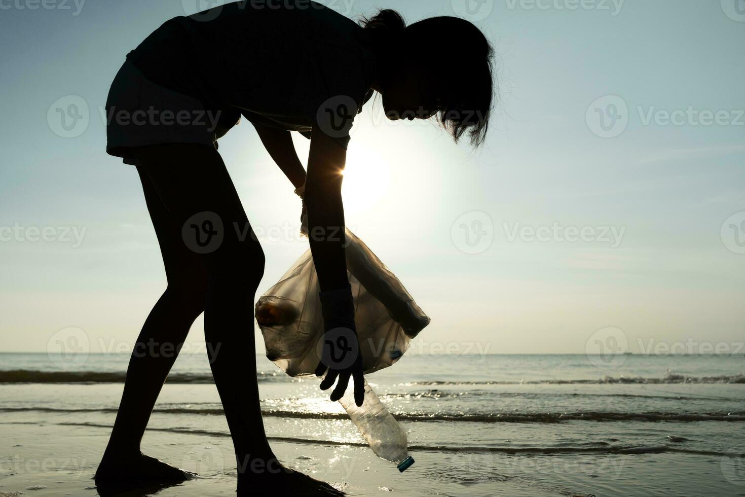 Save water. Volunteer pick up trash garbage at the beach and plastic bottles are difficult decompose prevent harm aquatic life. Earth, Environment, Greening planet, reduce global warming, Save world photo