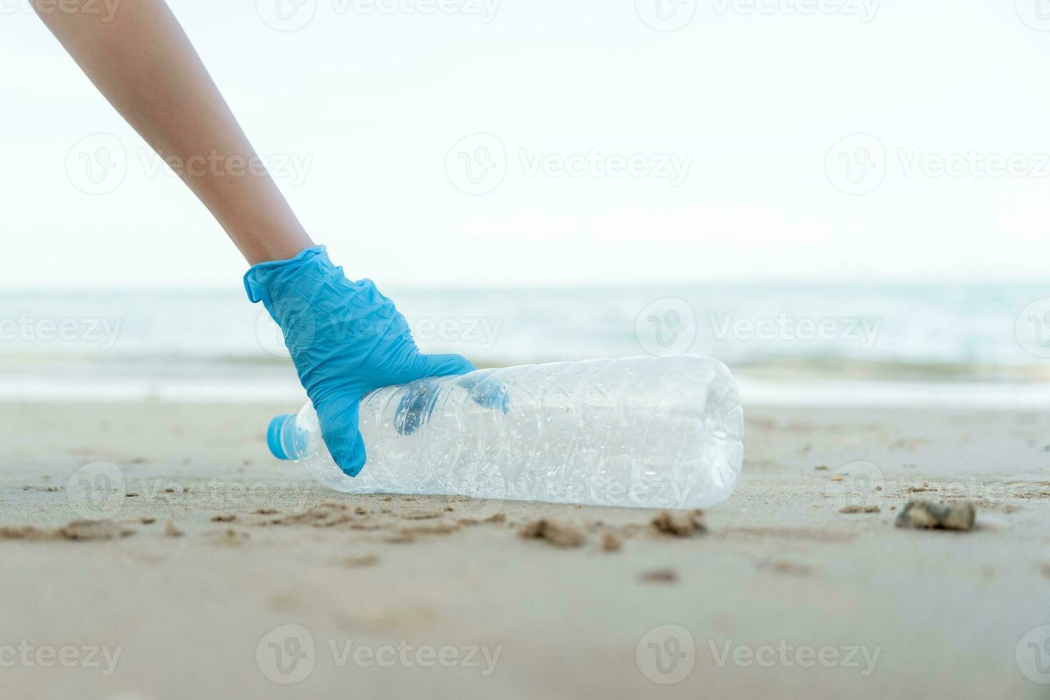 Save ocean. Volunteer pick up trash garbage at the beach and plastic bottles are difficult decompose prevent harm aquatic life. Earth, Environment, Greening planet, reduce global warming, Save world photo