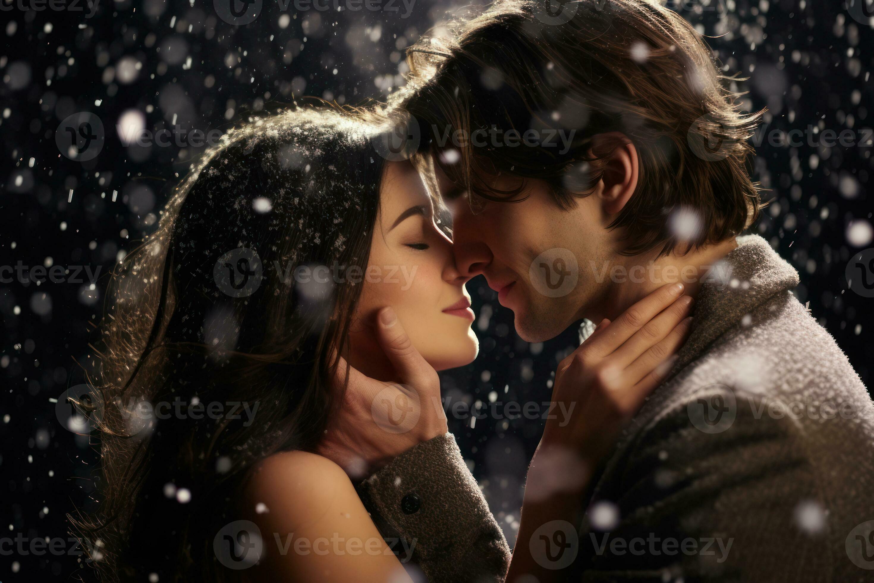 A closeup shot of a loving couple sharing a passionate kiss against a