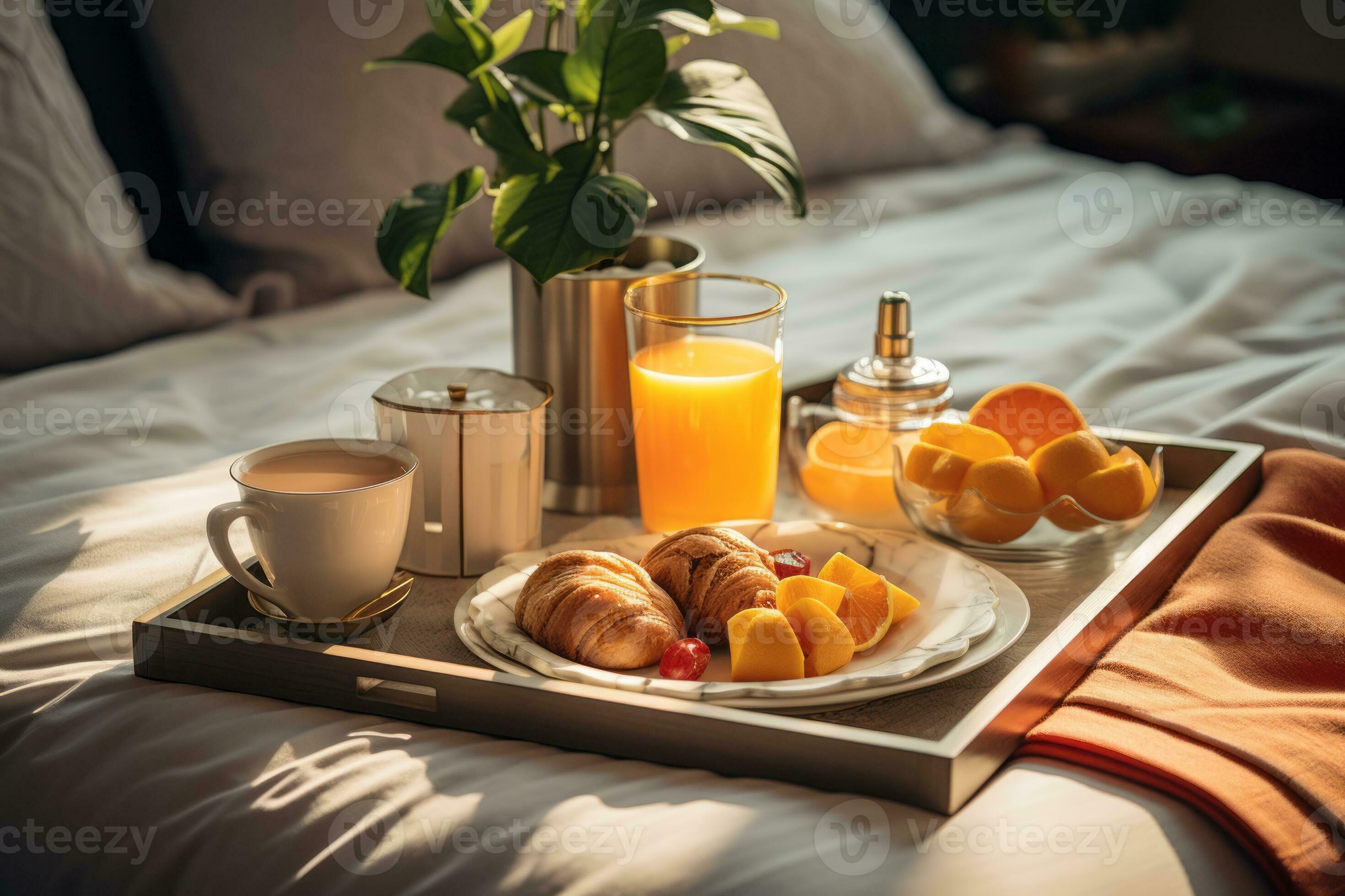 Room service tray with breakfast on bed in luxury hotel room