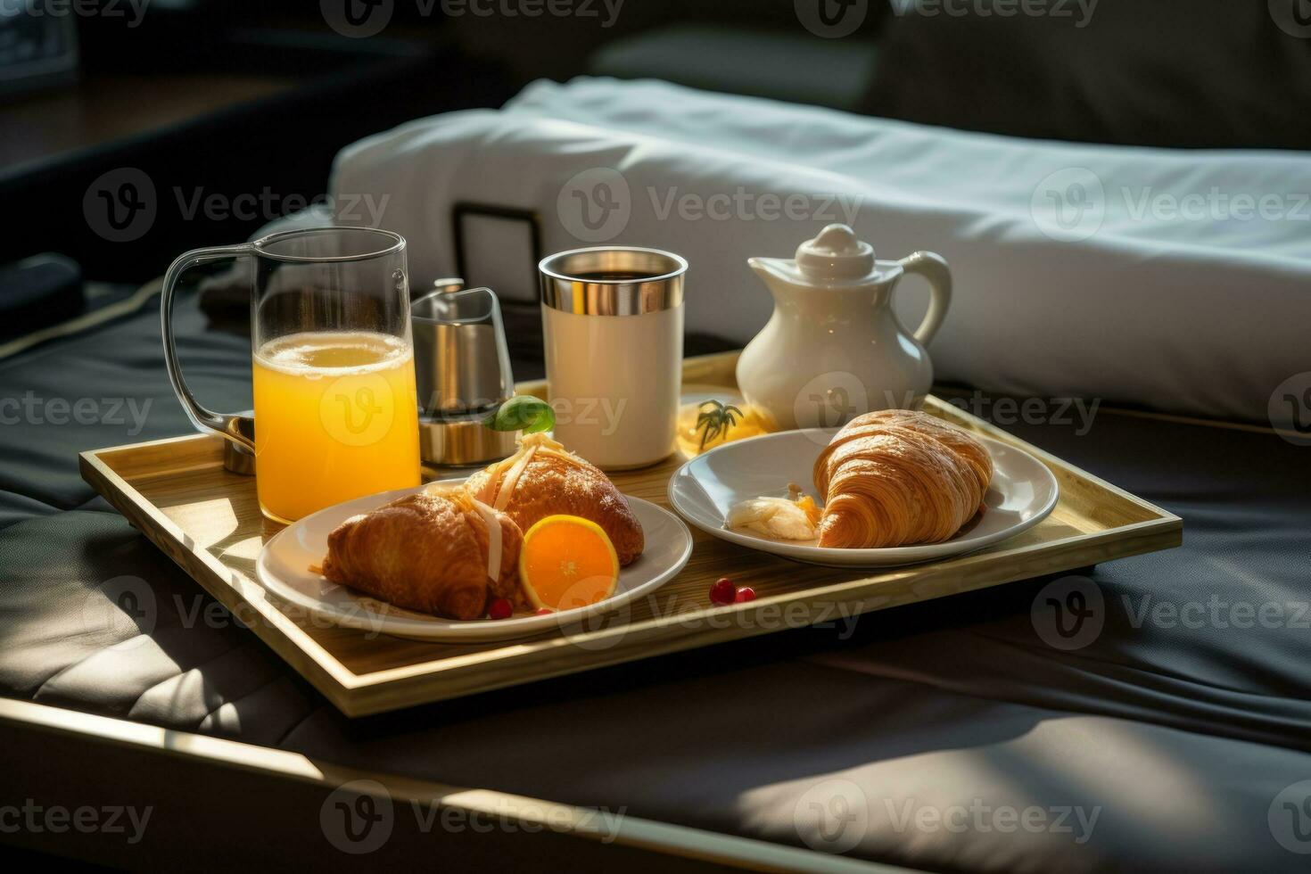Room service tray with breakfast on bed in luxury hotel room