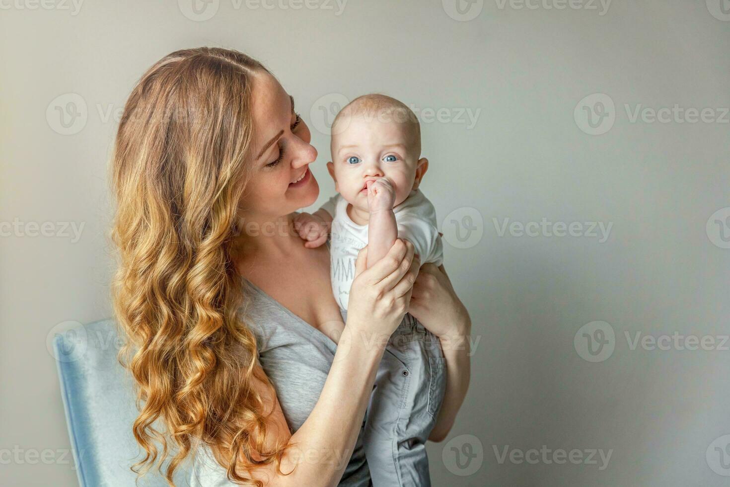 Young mother holding her newborn child photo