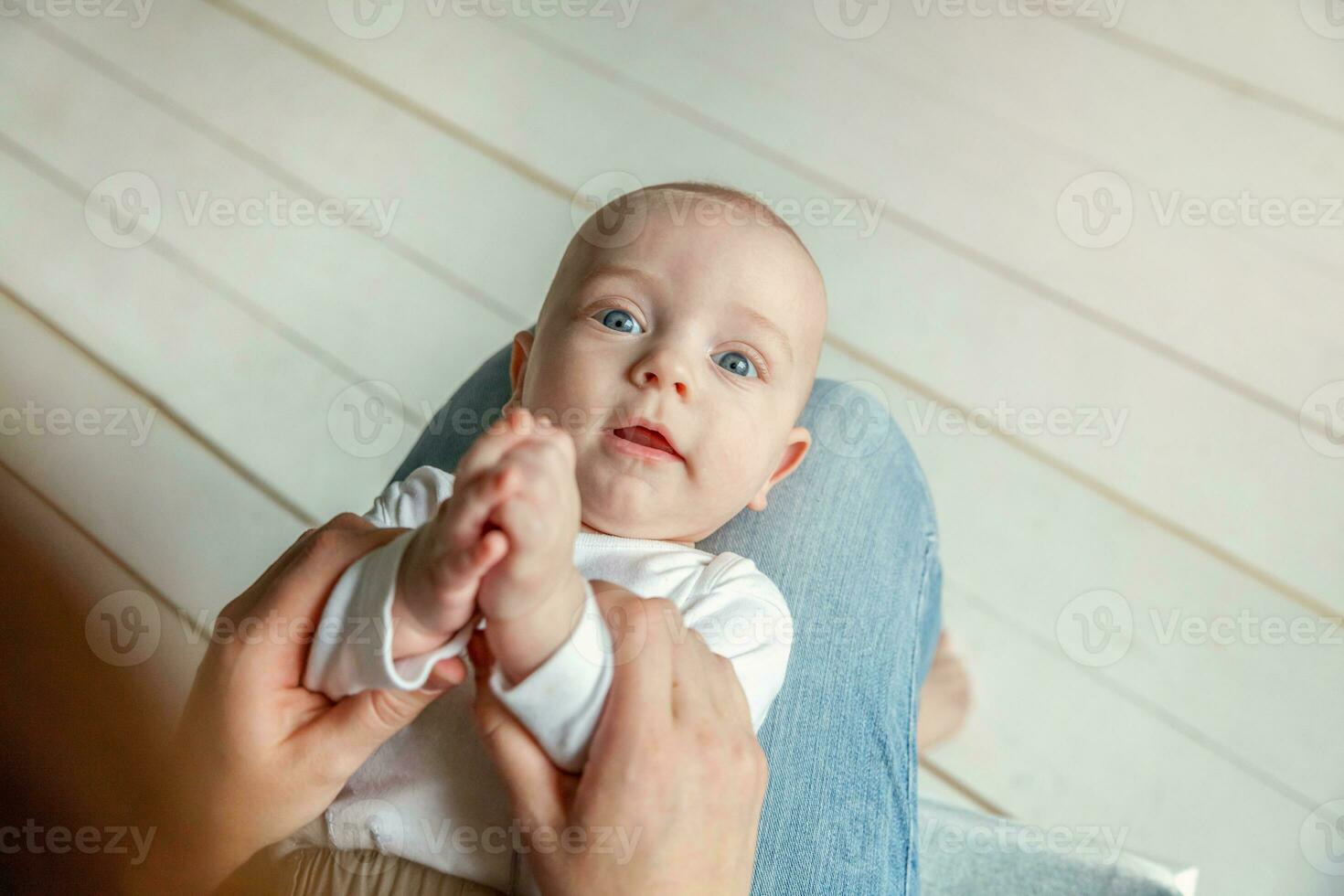 Newborn child lies on mother lap photo