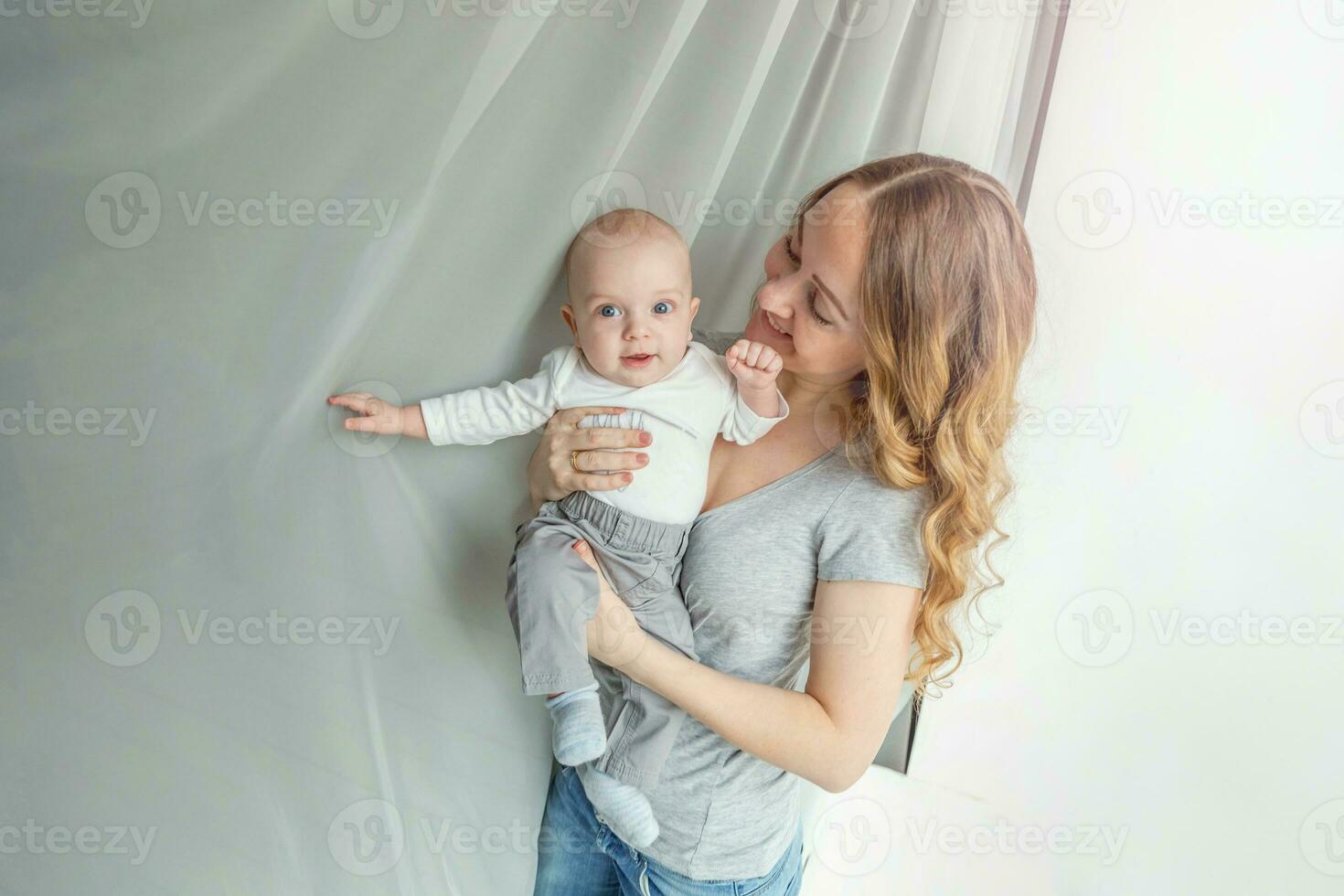 Young mother holding her newborn child photo