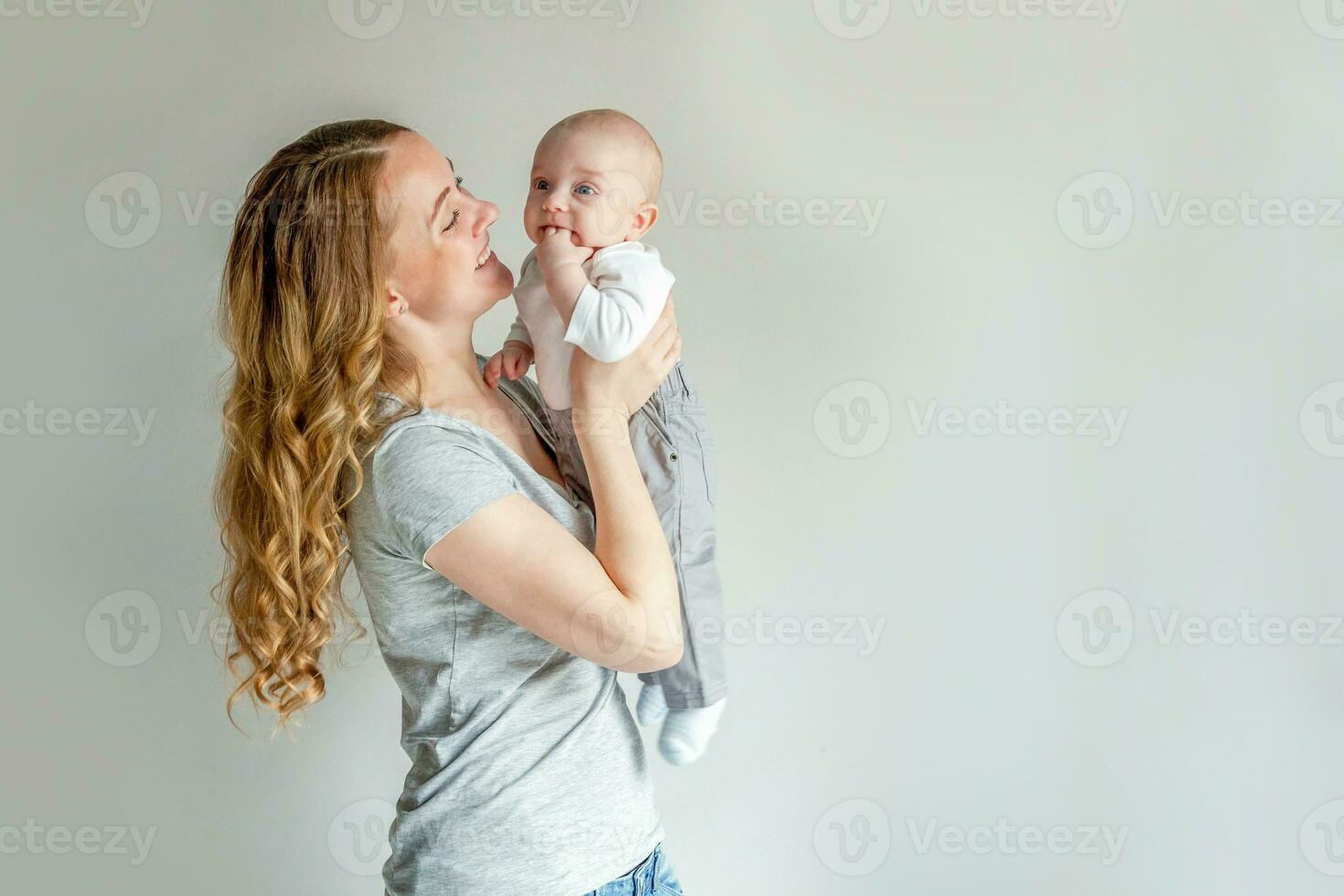 Young mother holding her newborn child photo