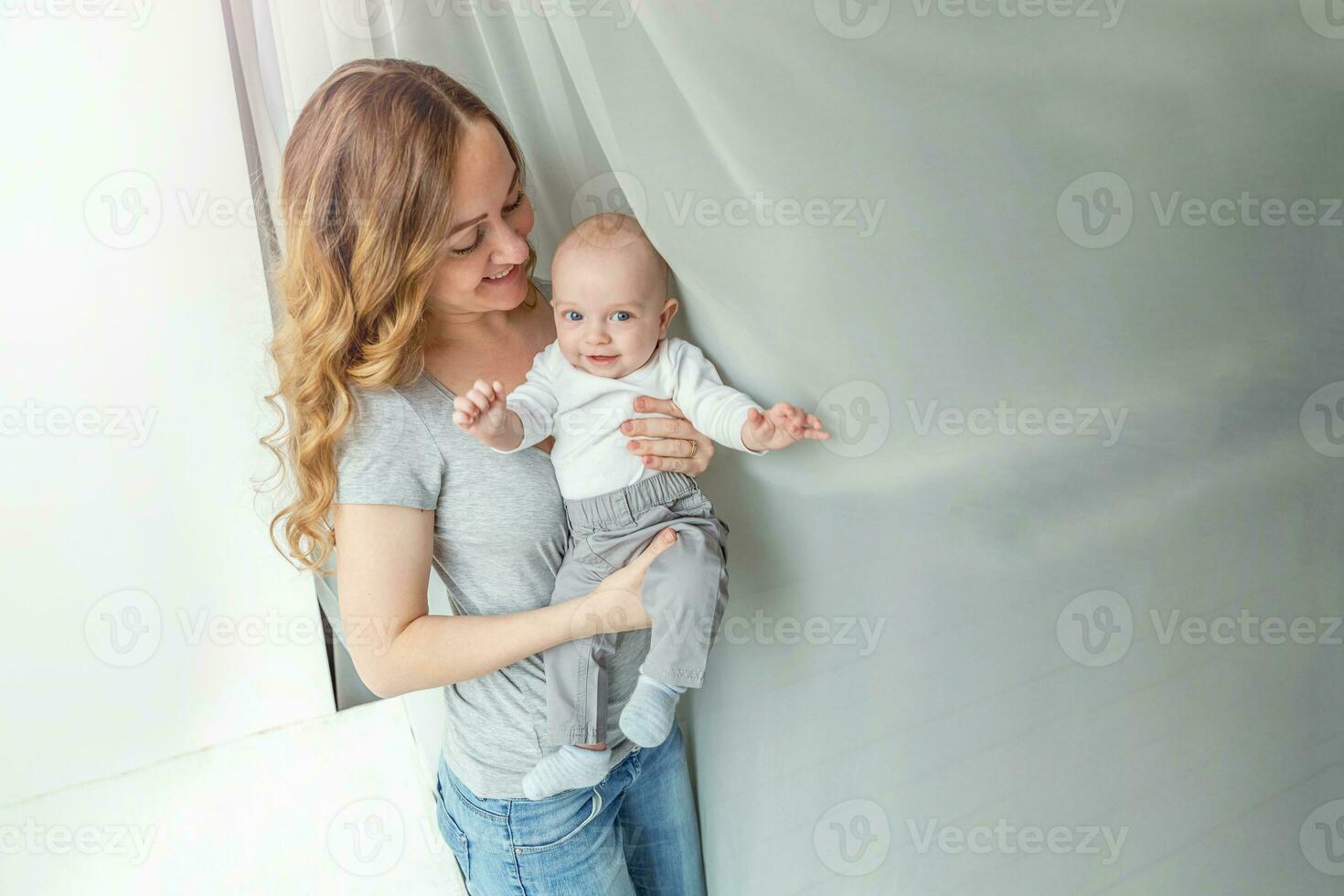 Young mother holding her newborn child photo