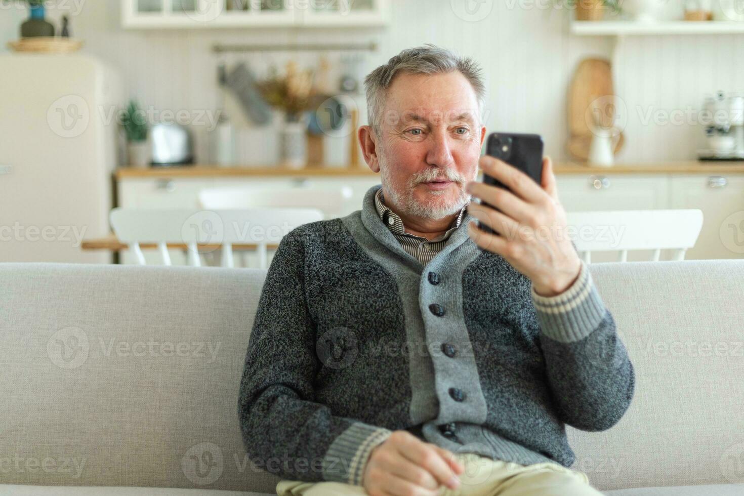 Happy middle aged senior man talk on video call with friends family. Laughing mature old senior grandfather having fun speaking with grown up children online. Older generation modern tech usage. photo