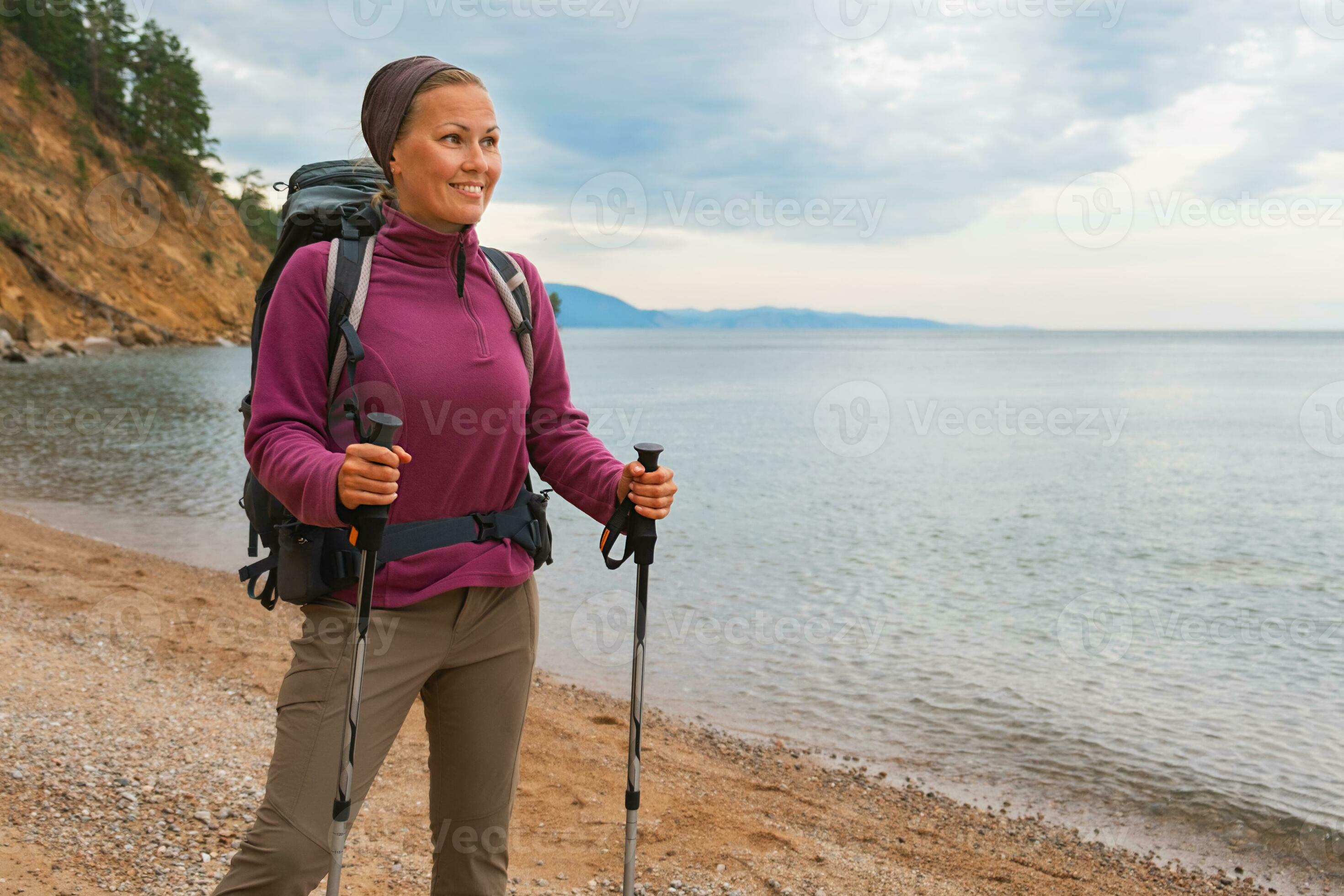 Hiking tourism adventure. Backpacker hiker woman looking at beautiful view.  Hiker girl lady tourist with backpack walking near lake. Young happy woman  enjoy hike trekking tourism active vacation. 30596844 Stock Photo at