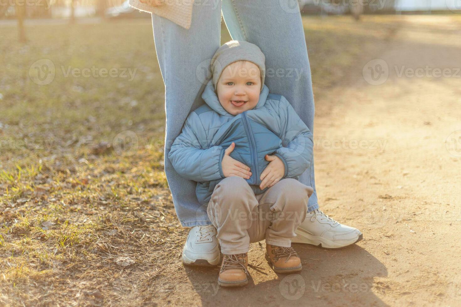 Happy family outdoor. Mother child on walk in park. Mom playing with baby son outdoor. Woman little baby boy resting walking in nature. Little toddler child and babysitter nanny having fun together. photo