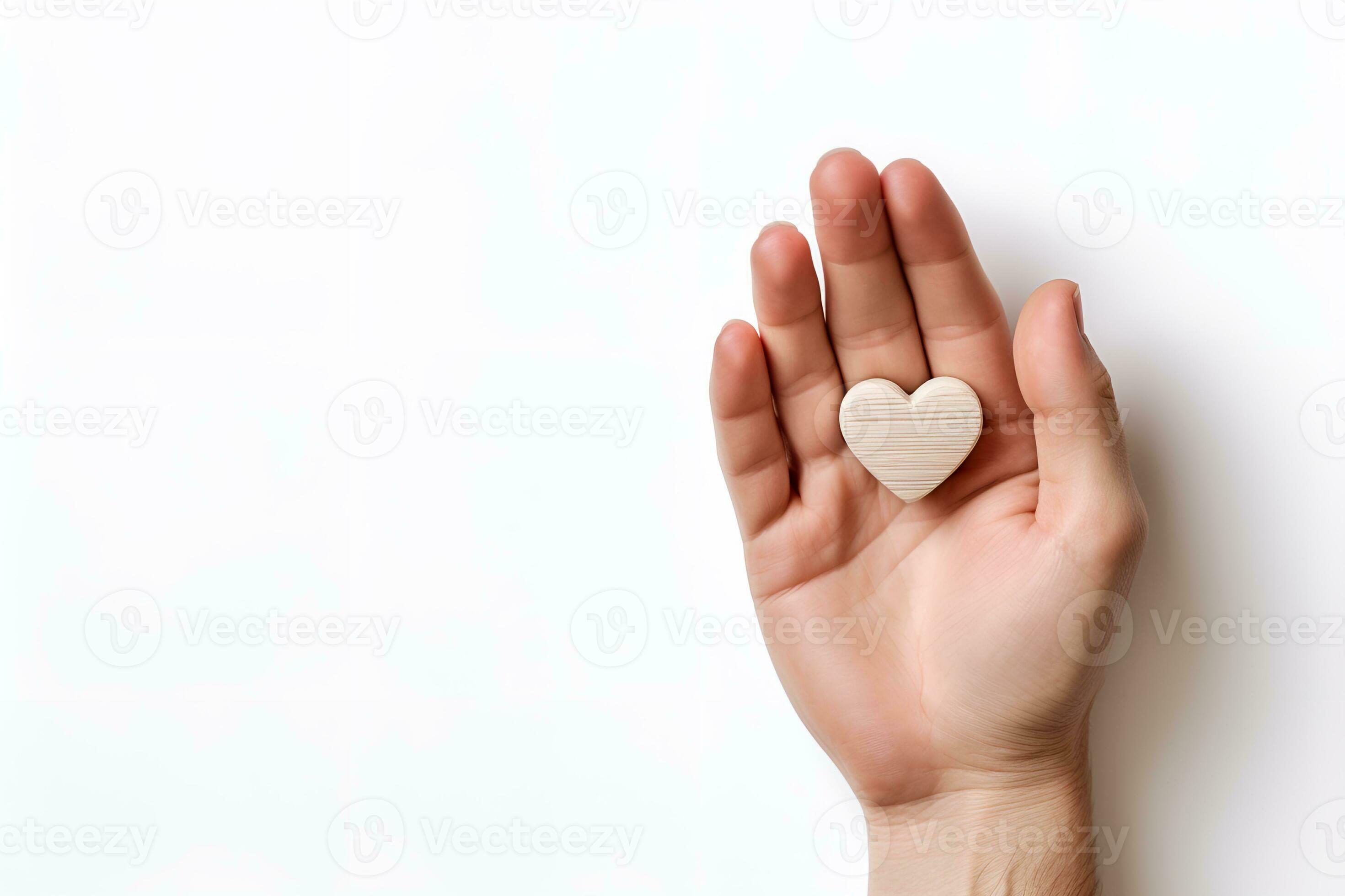 hand holding a heart shaped object white background copy space