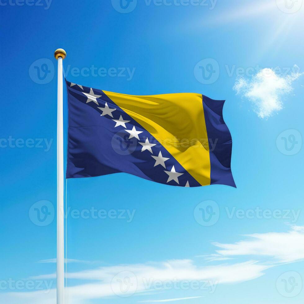 Waving flag of Bosnia on flagpole with sky background. photo