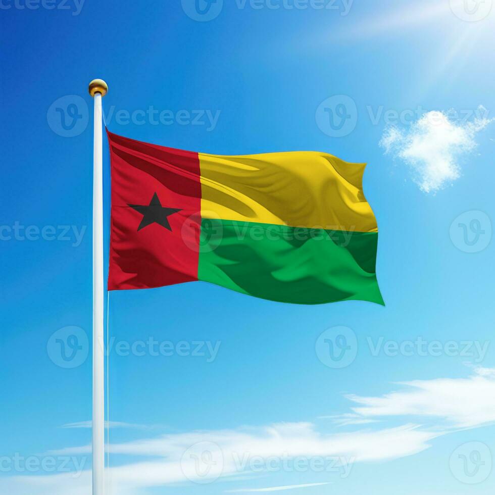 Waving flag of Guinea-Bissau on flagpole with sky background. photo