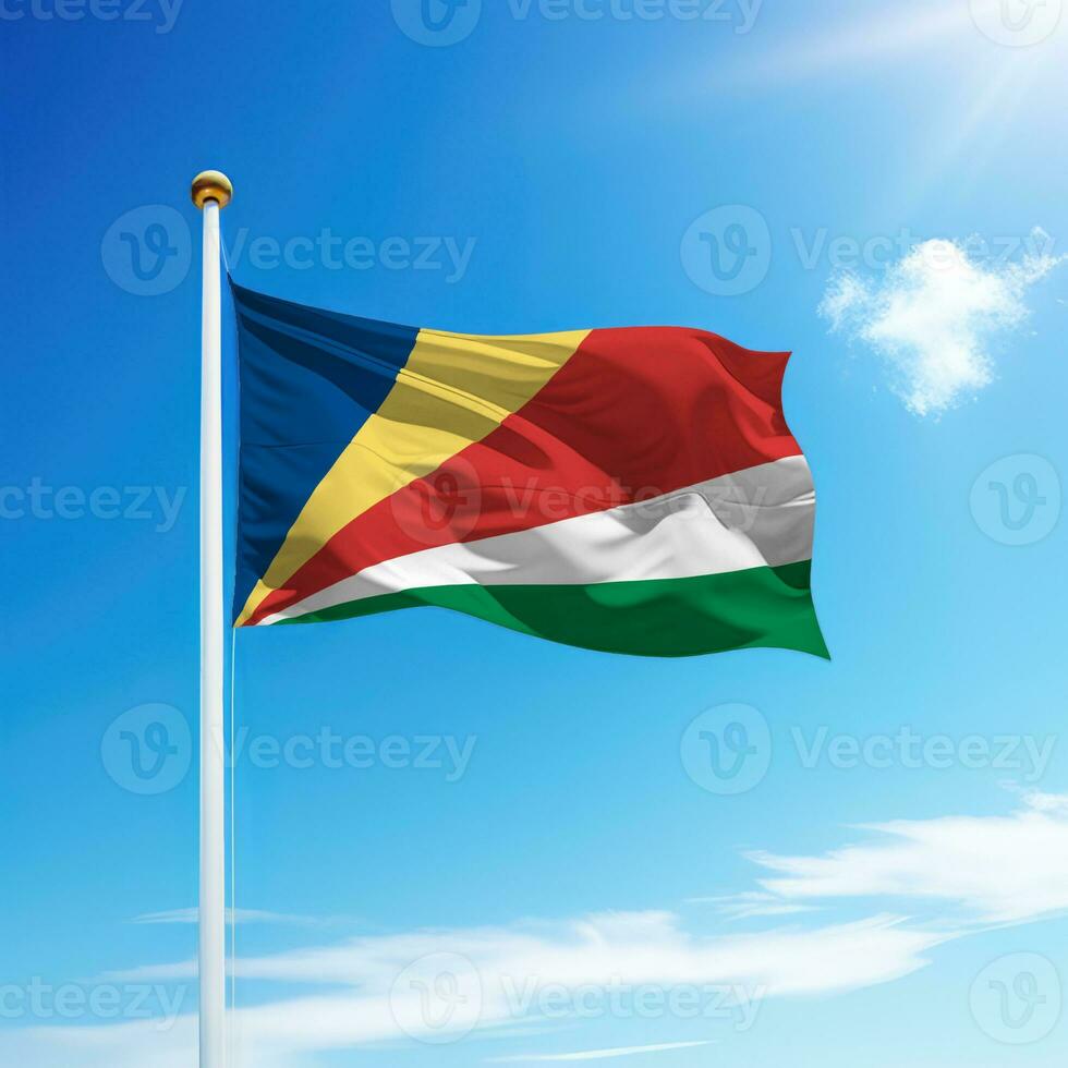 Waving flag of Seychelles on flagpole with sky background. photo