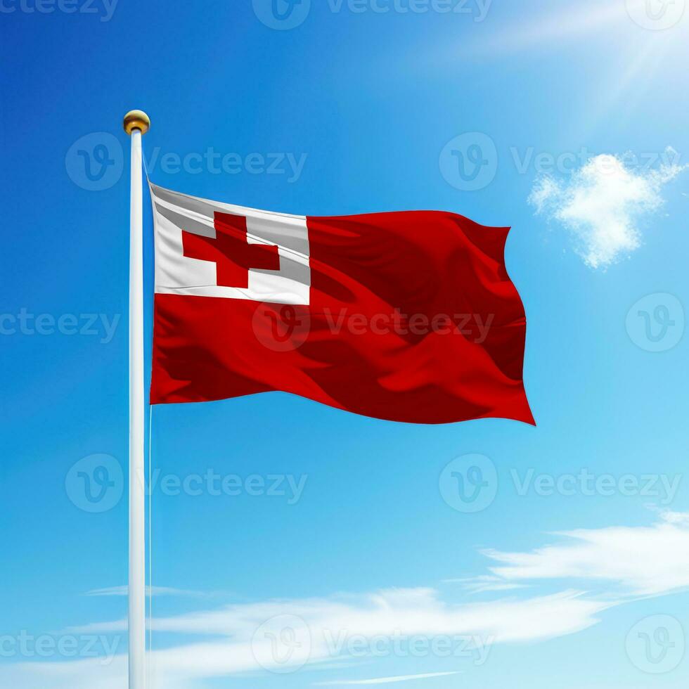Waving flag of Tonga on flagpole with sky background. photo