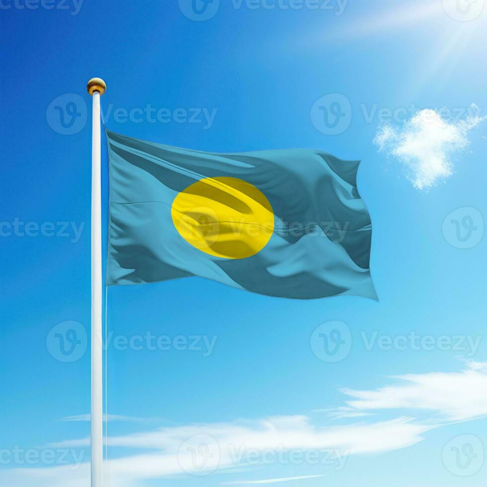 Waving flag of Palau on flagpole with sky background. photo