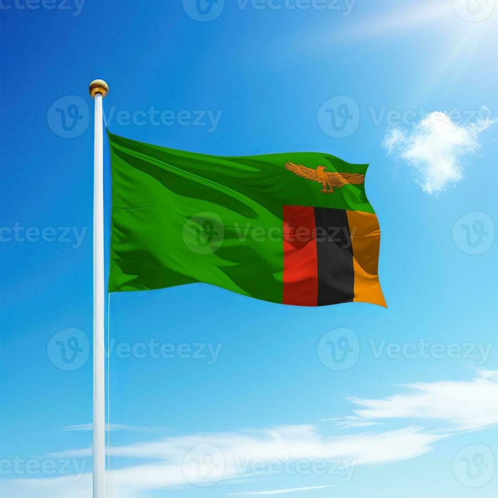 Waving flag of Zambia on flagpole with sky background. photo