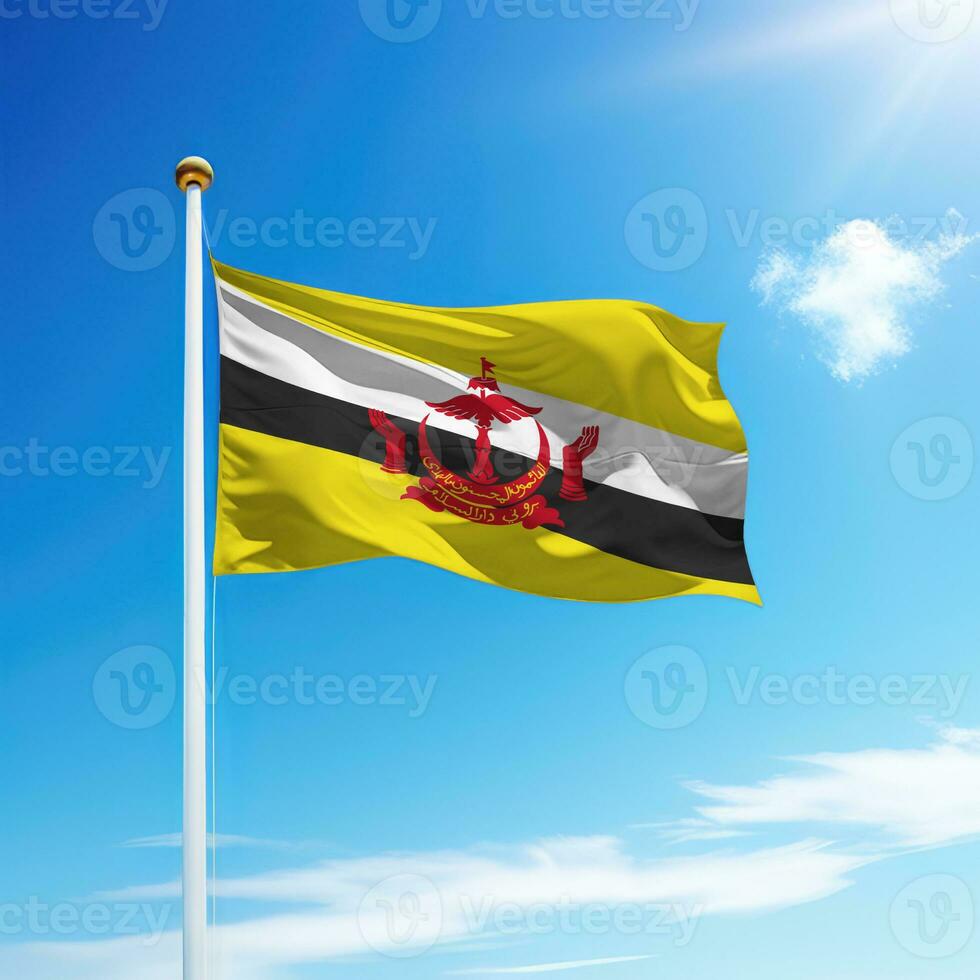 Waving flag of Brunei on flagpole with sky background. photo