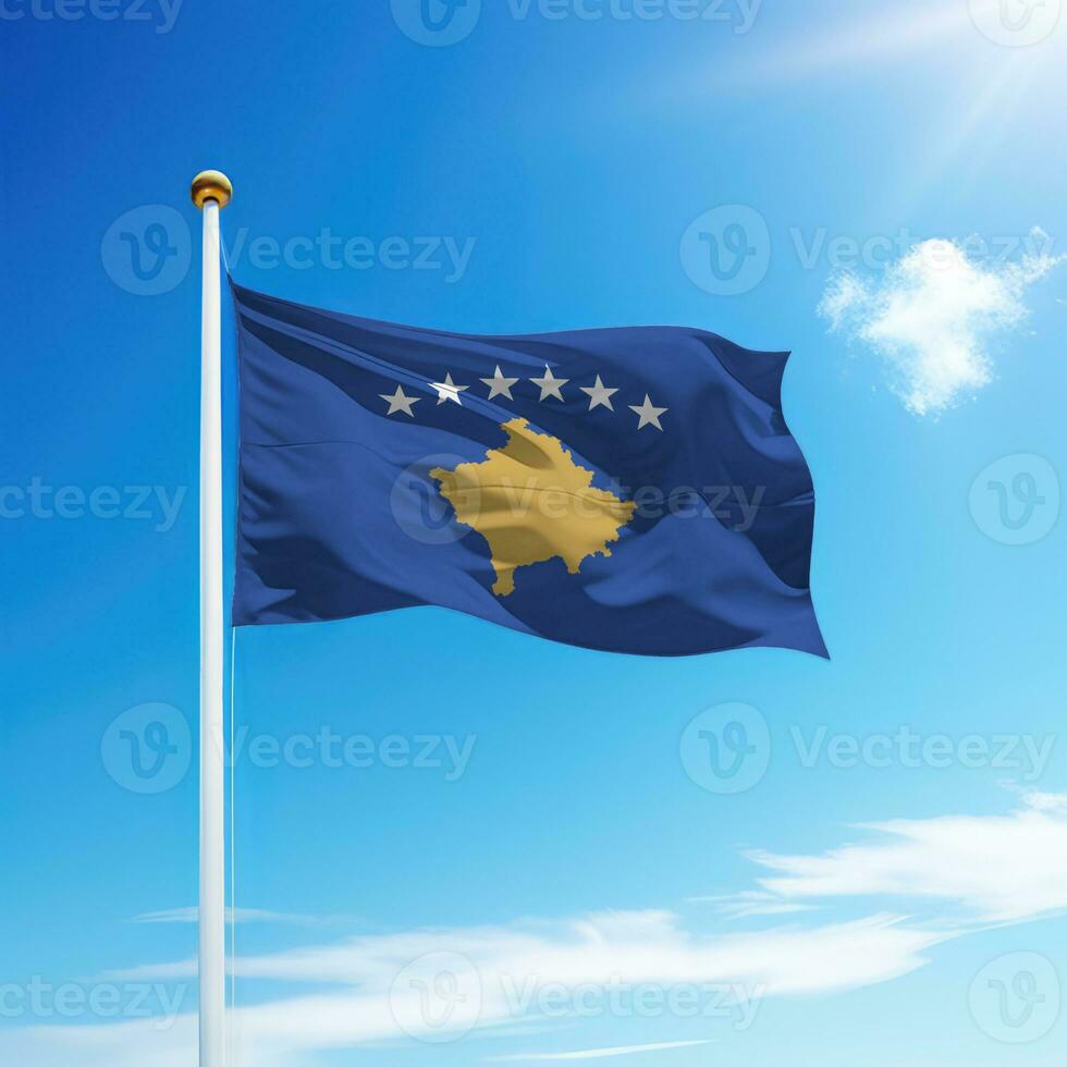 Waving flag of Kosovo on flagpole with sky background. photo