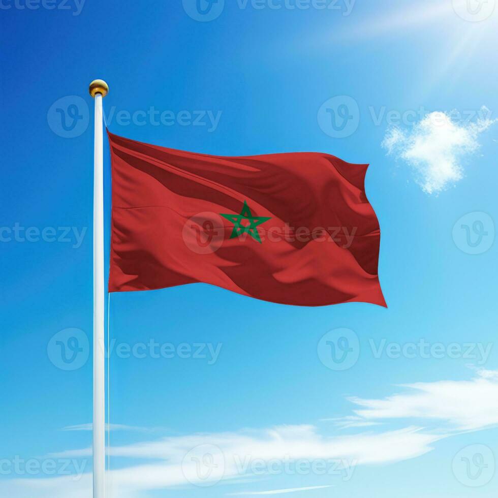 Waving flag of Morocco on flagpole with sky background. photo