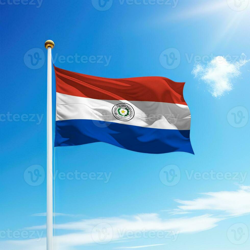 Waving flag of Paraguay on flagpole with sky background. photo