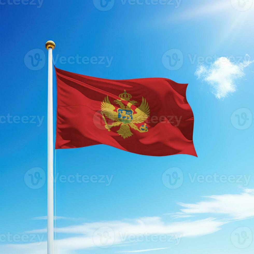 Waving flag of Montenegro on flagpole with sky background. photo