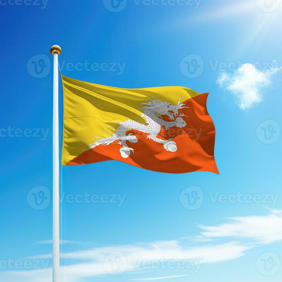 Waving flag of Bhutan on flagpole with sky background. photo