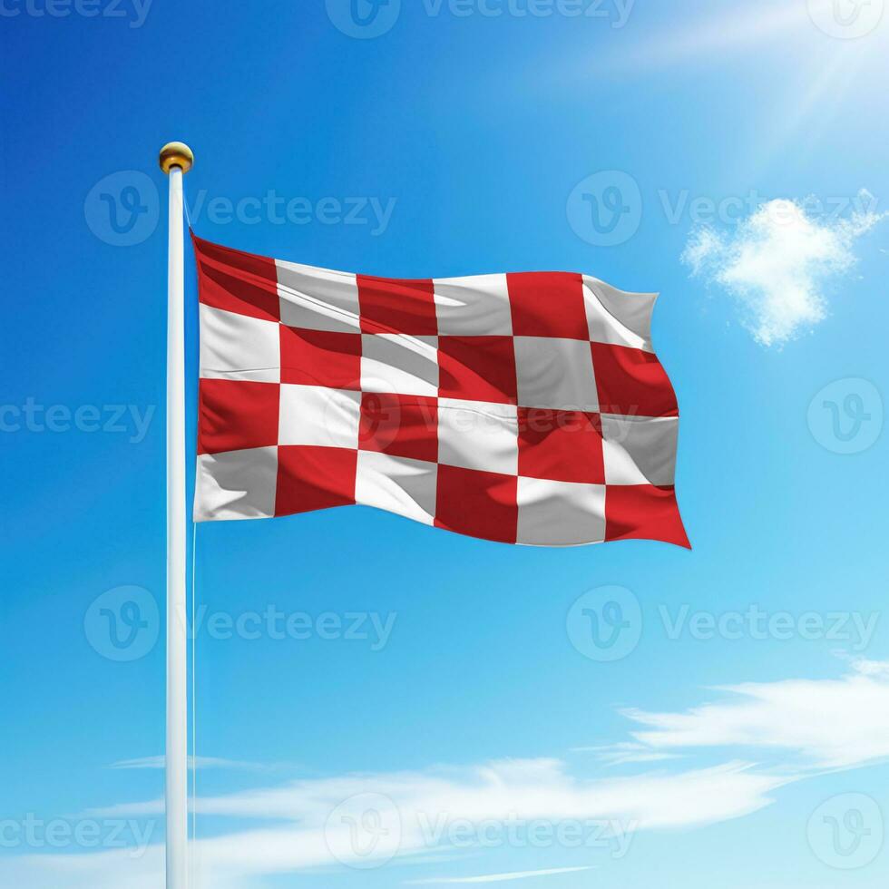 Waving flag of North Brabant is a state of Netherlands on flagpole photo