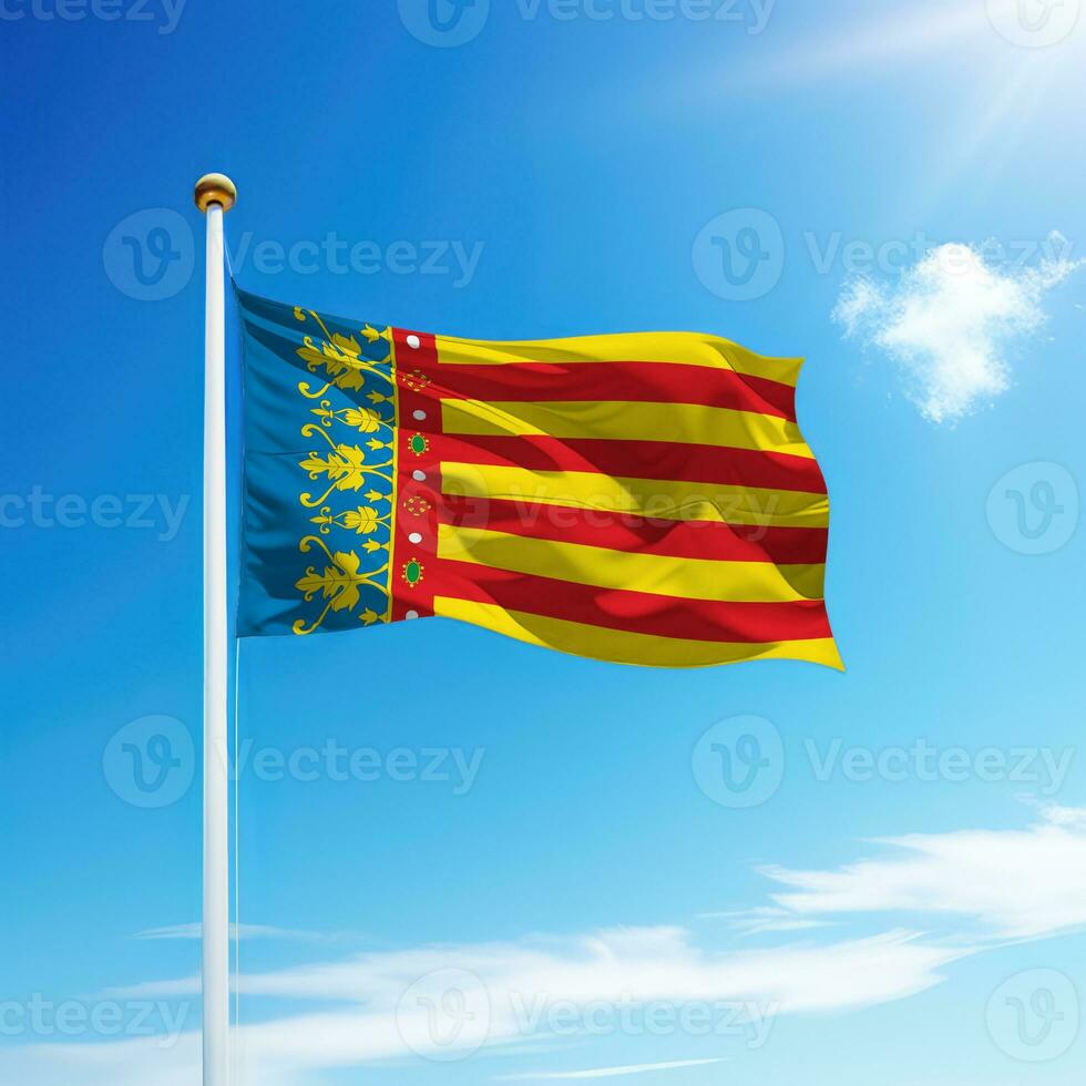 Waving flag of Valencia is a community of Spain on flagpole photo