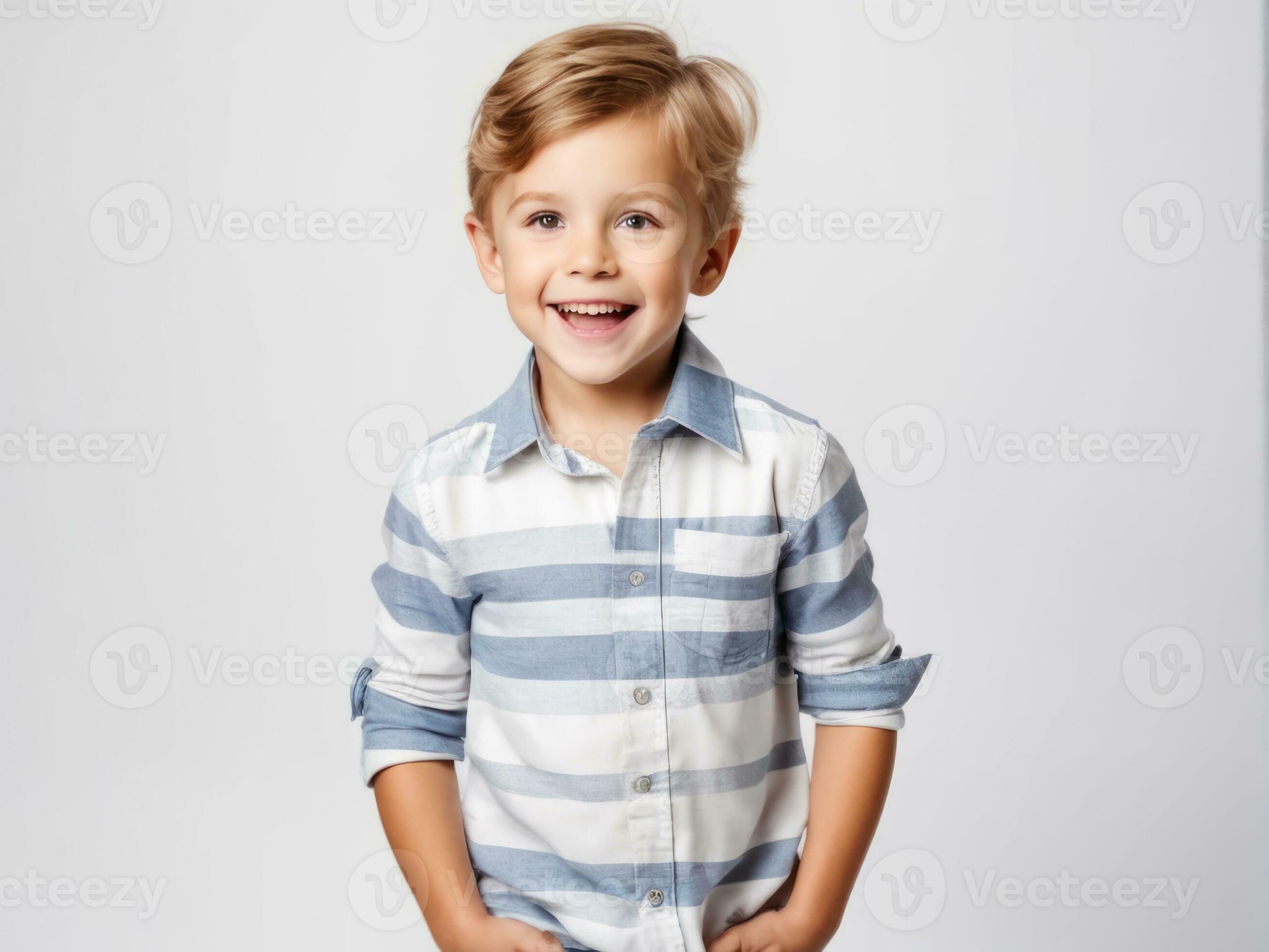 Portrait of young excited shocked crazy smiling boy child kid on studio