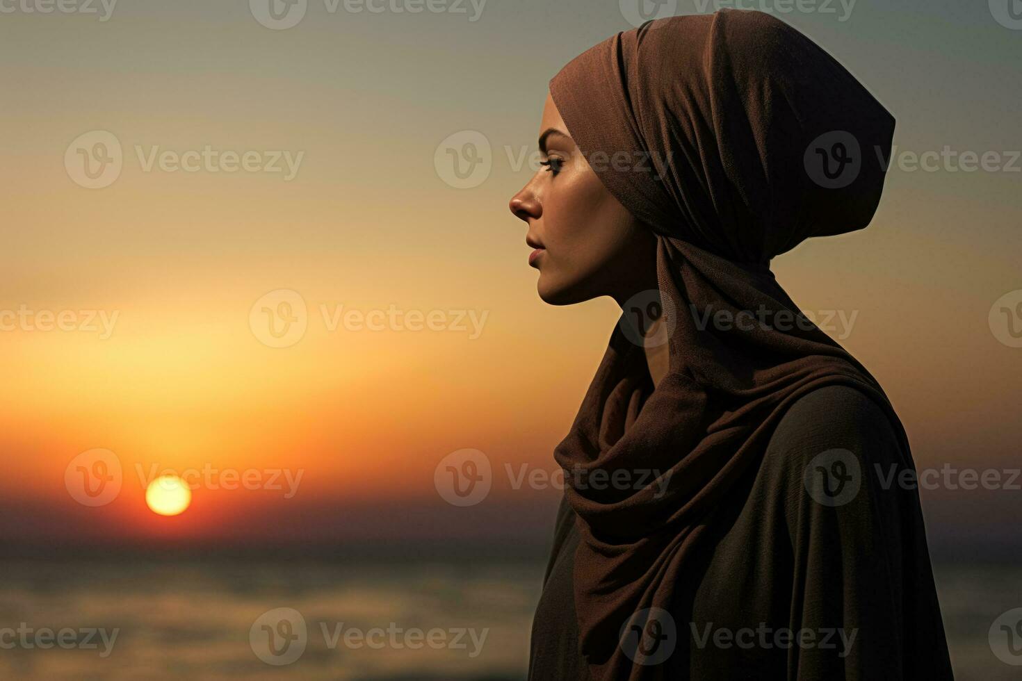 A reflective cancer patient gazing at a sunset isolated on a melancholic gradient background photo