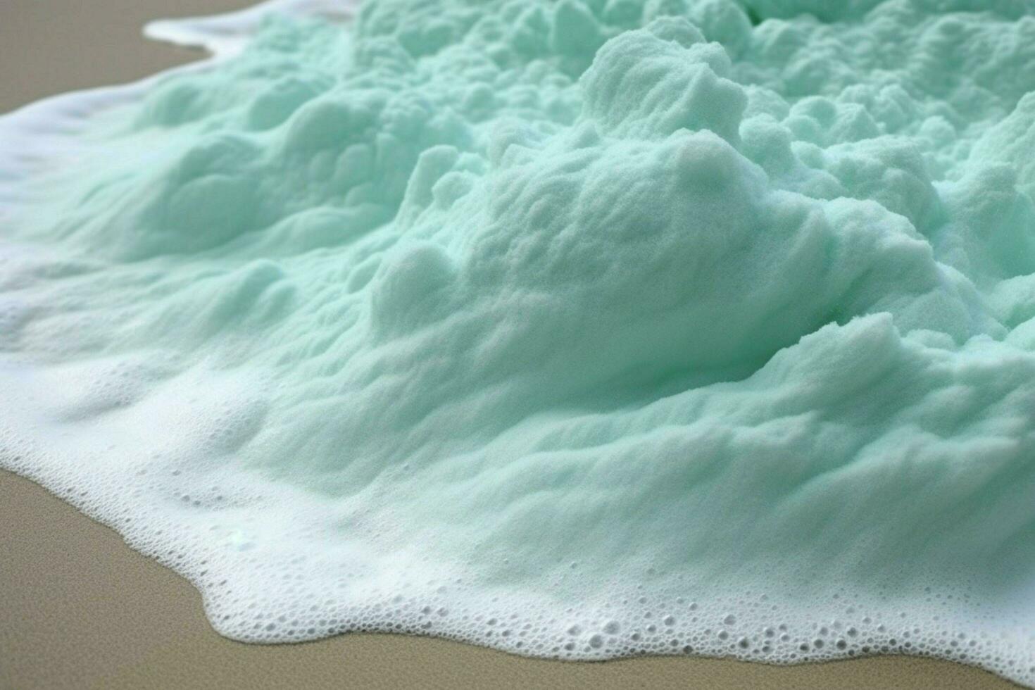 The seafoam creates a frothy canvas on the sand photo