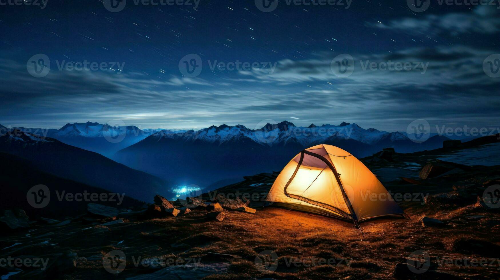 Camping in the mountains at night. The tent is on the top of the mountain. photo
