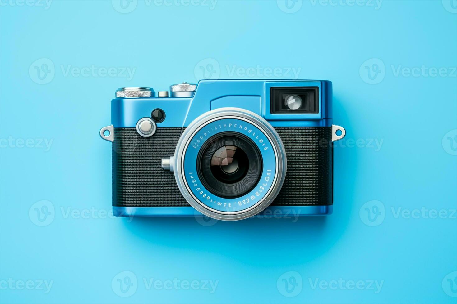 Vintage film camera on blue background. Top view with copy space photo