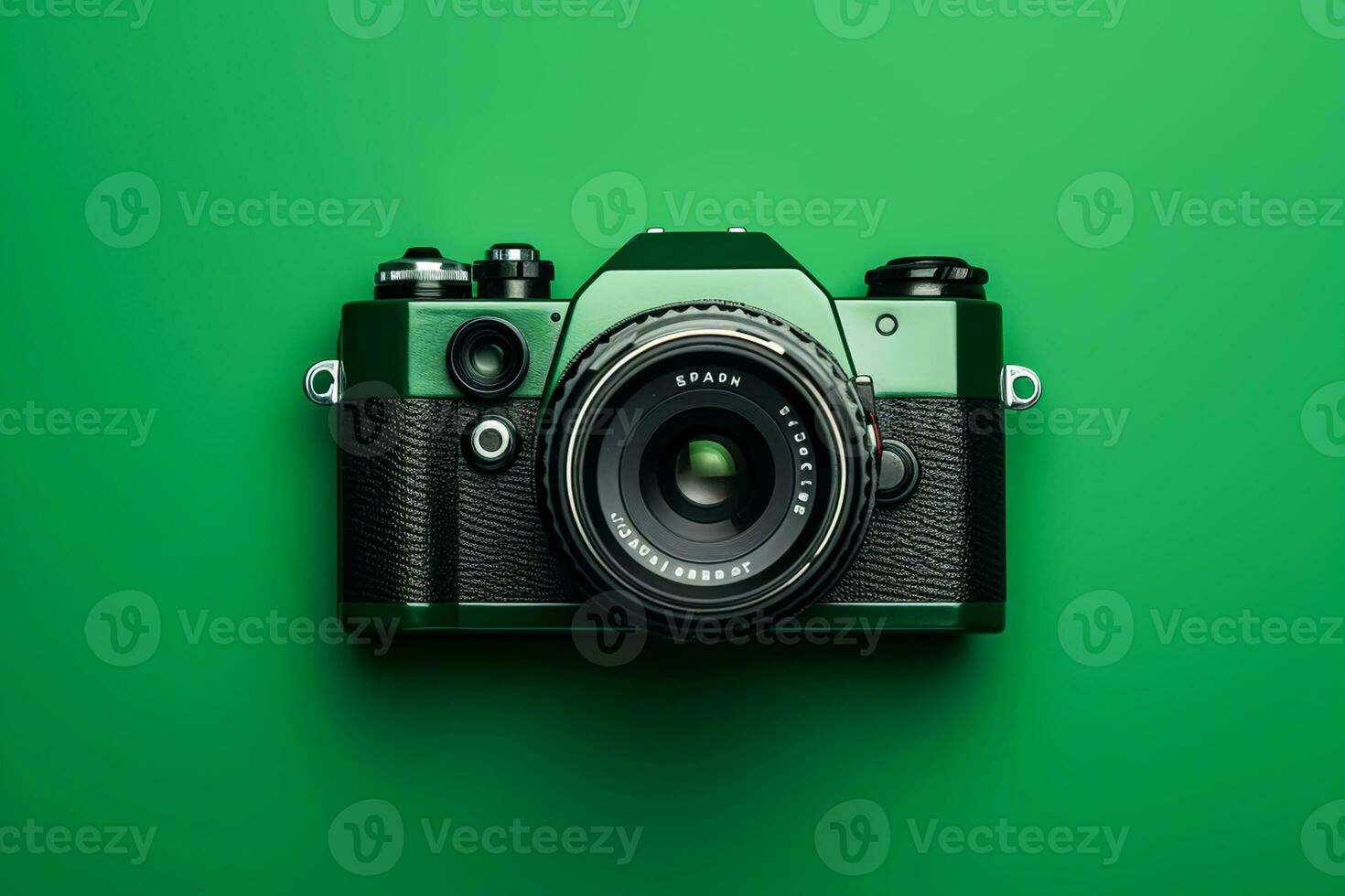 Retro camera on a green background, top view, flat lay photo