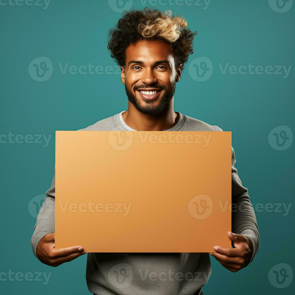 Handsome young man holding a blank sheet of paper photo