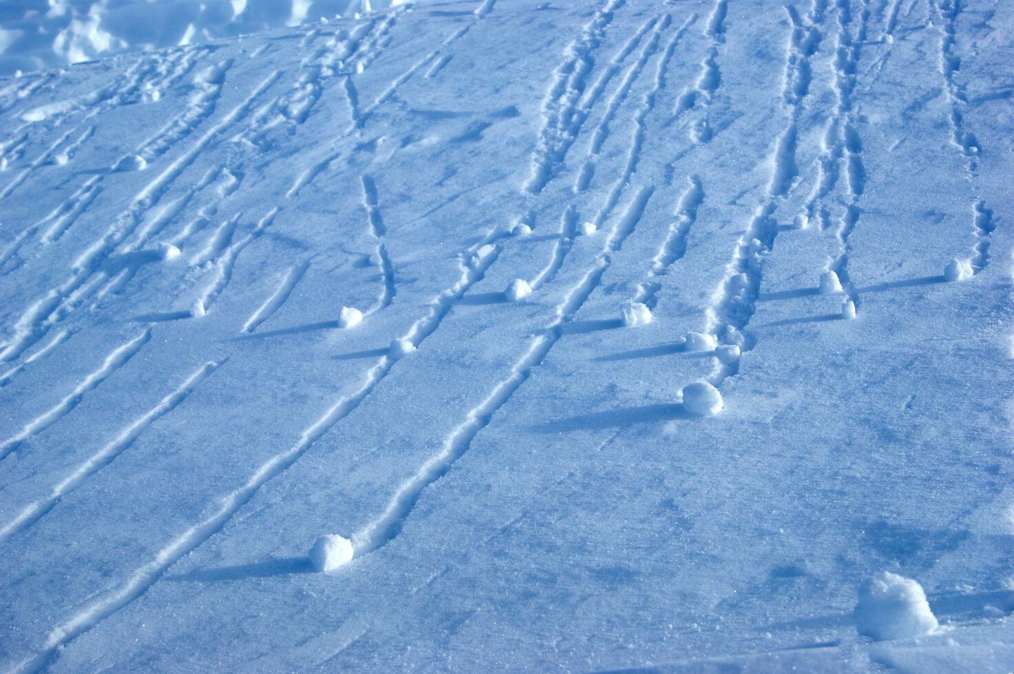 a snowboarder is riding down a slope photo