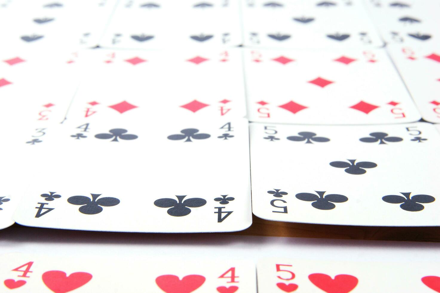 a pile of playing cards on a table photo