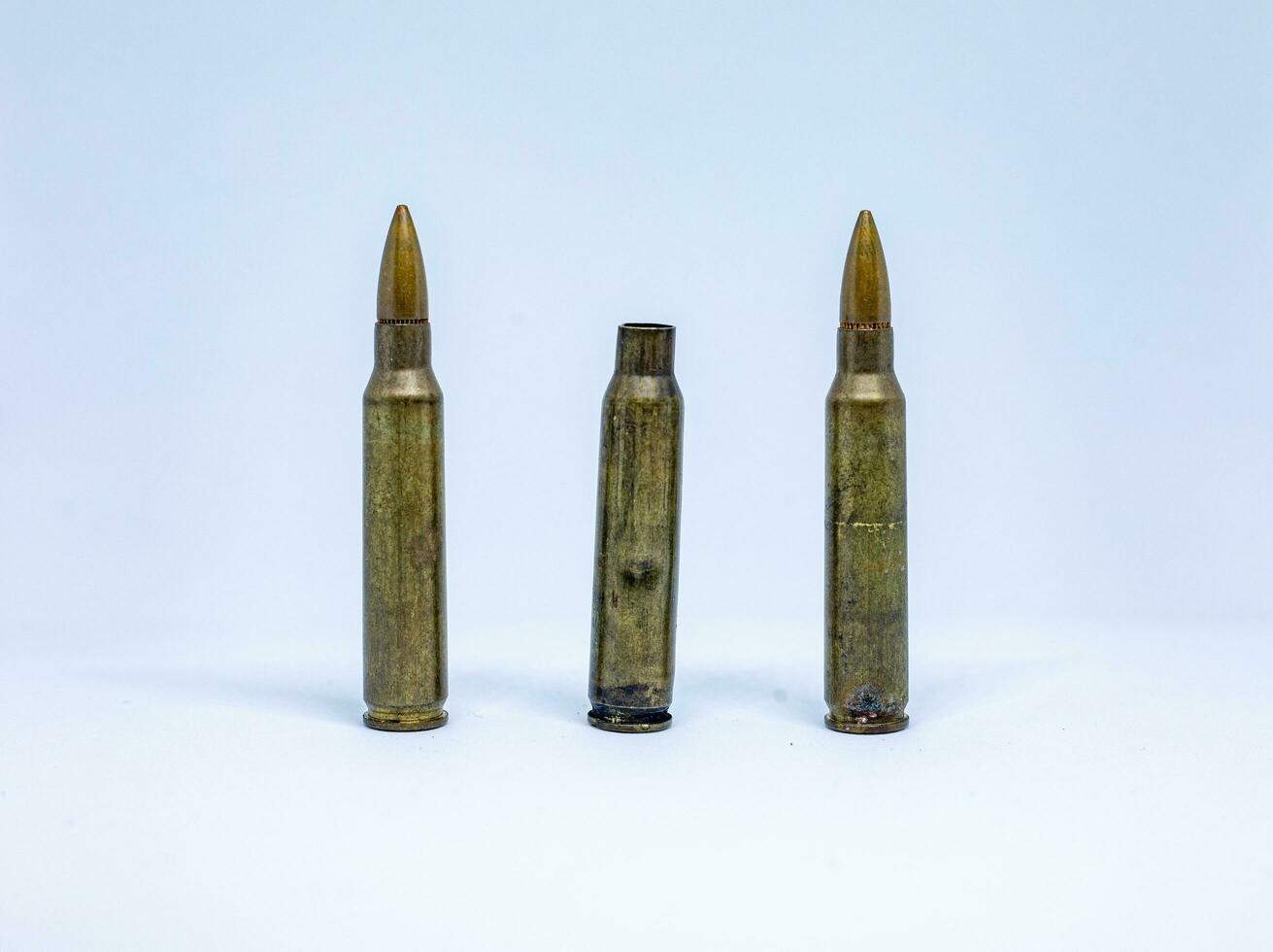 Bullet ammunition for rifle isolated on white background. Military ammo for pistol or rifle. photo