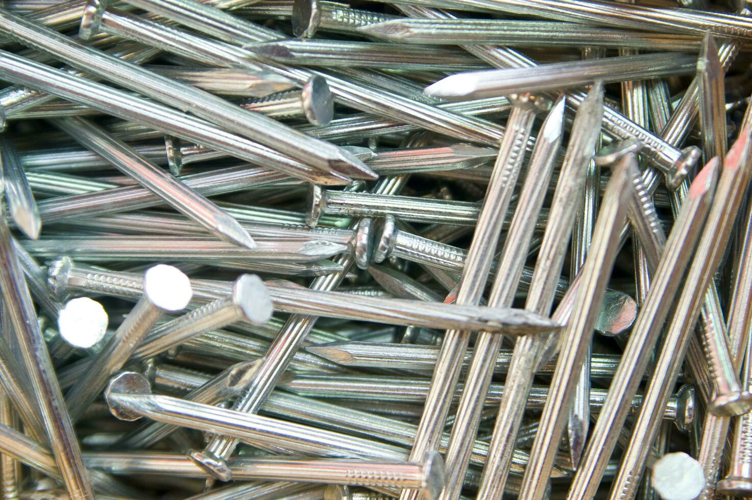 a pile of nails with a variety of sizes photo