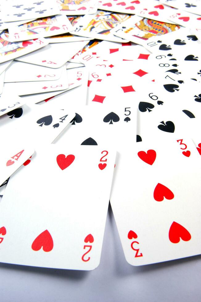 a pile of playing cards on a table photo