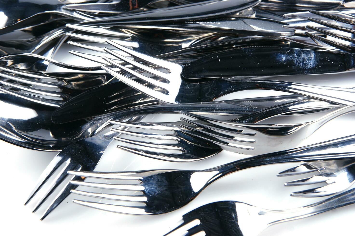 a bunch of silver forks and knives photo