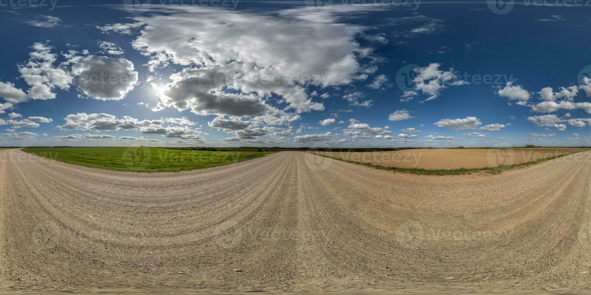 360 hdri panorama on white sand gravel road with clouds on blue sky in equirectangular spherical  seamless projection, skydome replacement in drone panoramas, game development sky dome or VR content photo